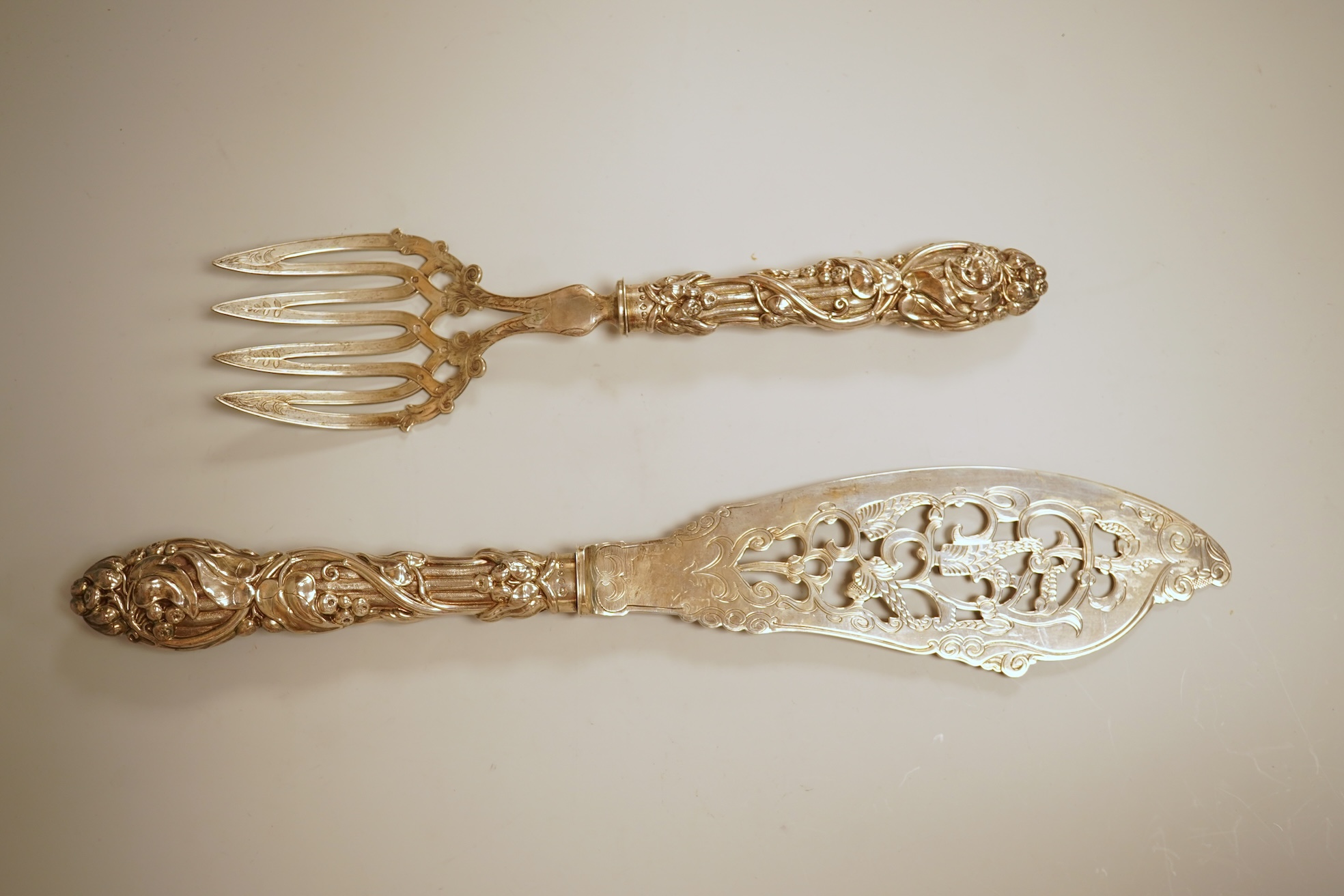 A pair of Victorian ornate silver fish servers, by John Gilbert, Birmingham, 1864, 34.1cm.